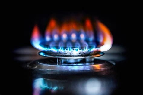blue flame with orange tips on gas stove